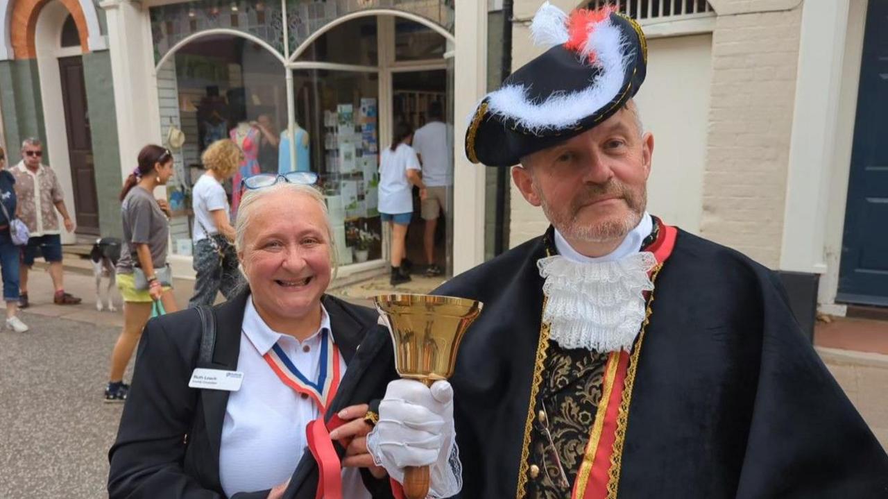 Woodbridge's first town crier Patrick Gillard with county councillor Ruth Leach