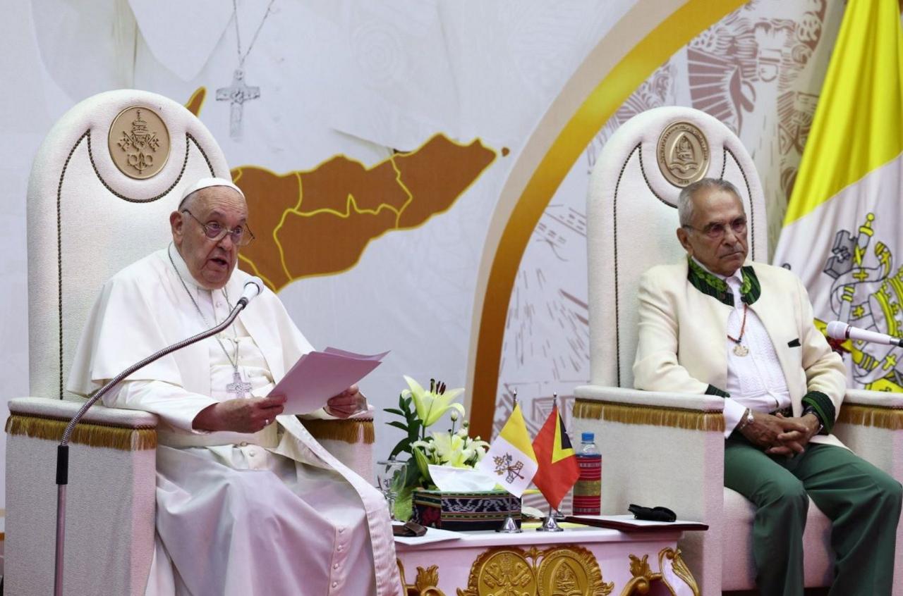 Pope Francis sits and delivers a speech next to East Timor's President Jose Ramos-Horta.