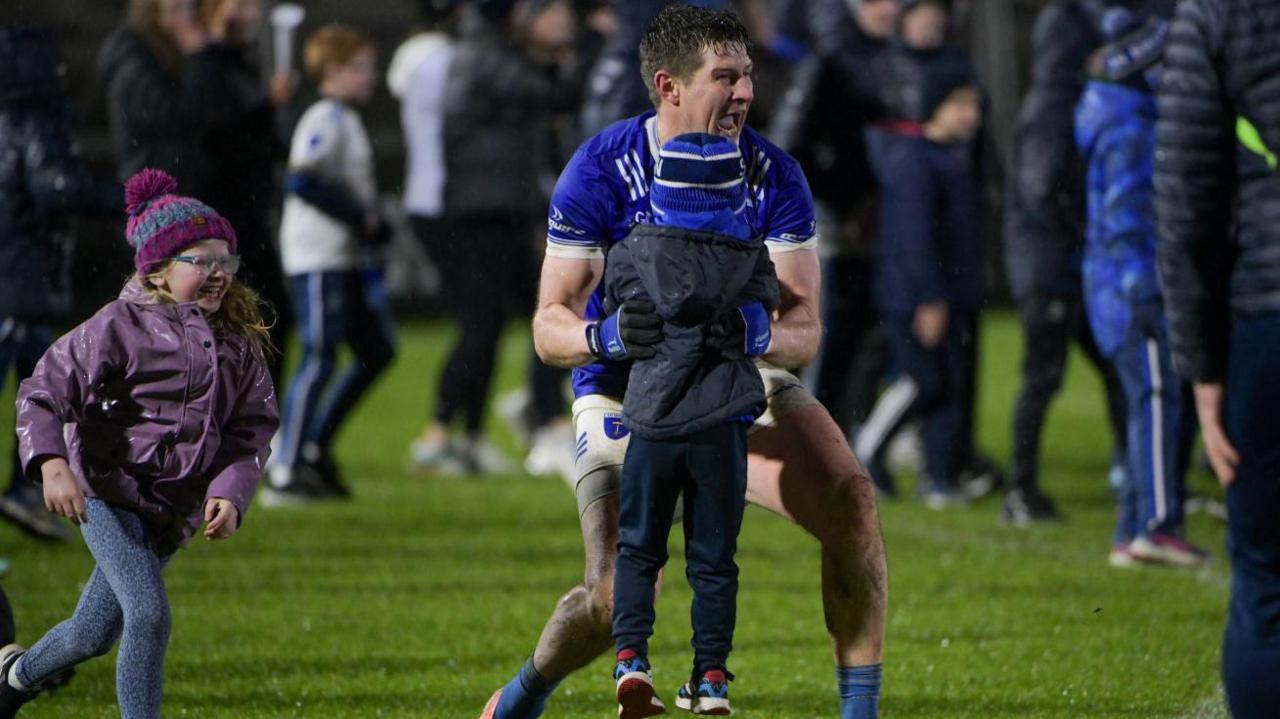 Darren Hughes celebrates with his children, Cillian and Ava