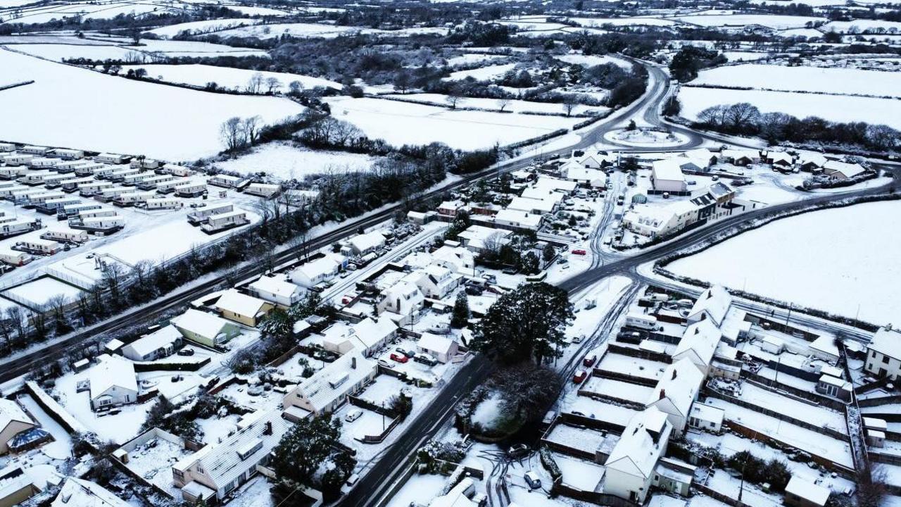 Aerial view of Pembrokeshire houses and caravans with snowy fields
