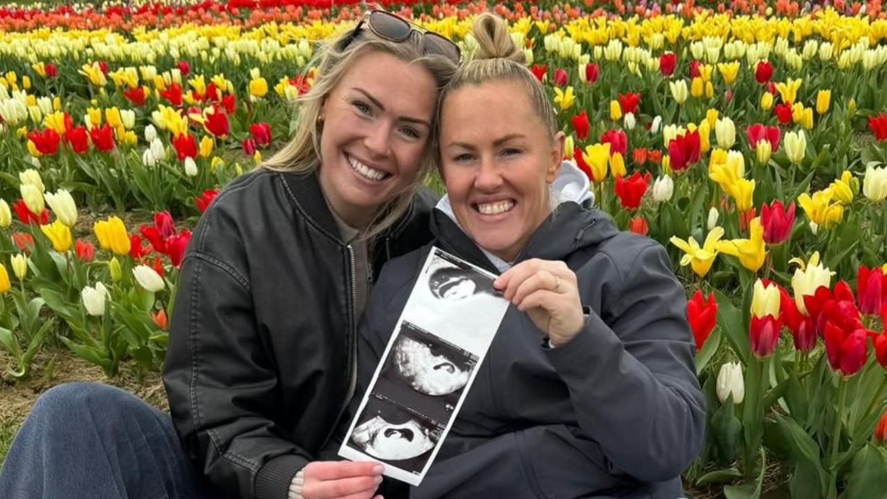 Rosie Galligan and Marlie Packer hold a picture of a pregnancy scan 