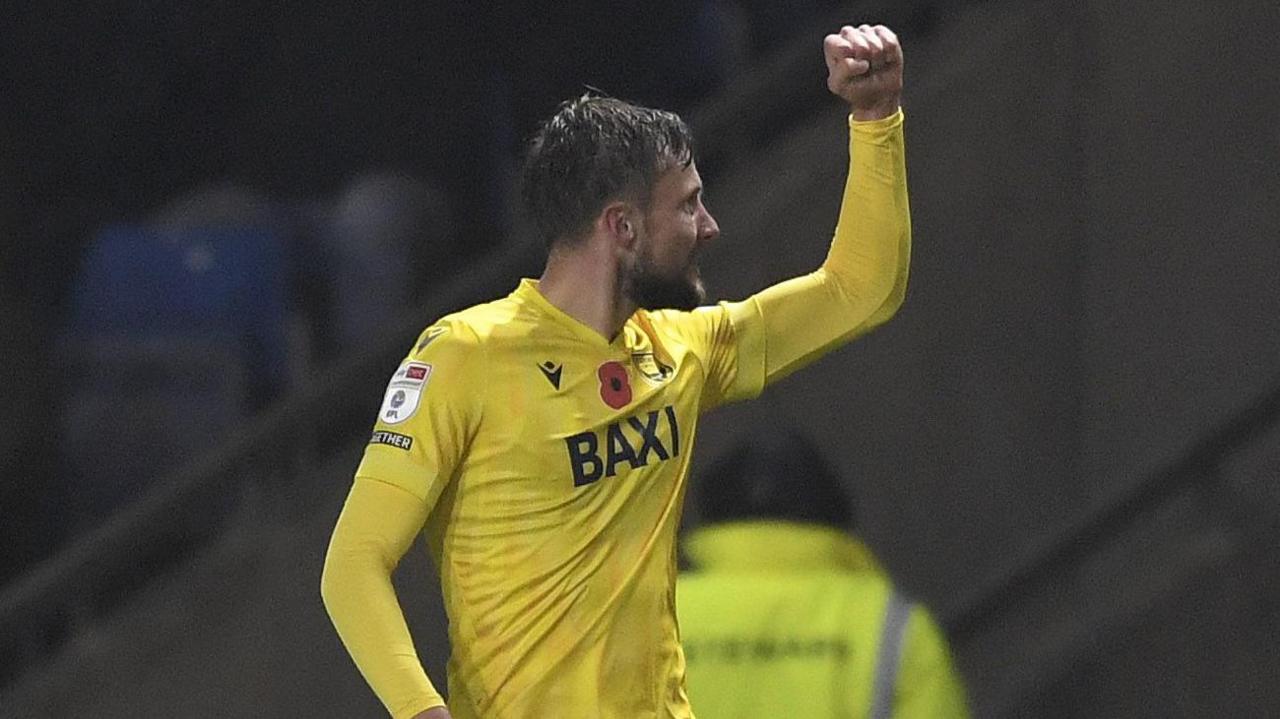 Hidde ter Avest holds his fist in the air in celebration after scoring