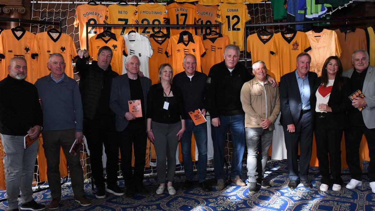 Eight former Wolves players in a line-up in front of Wolves shirts with Steve Plant's wife Andrea. 