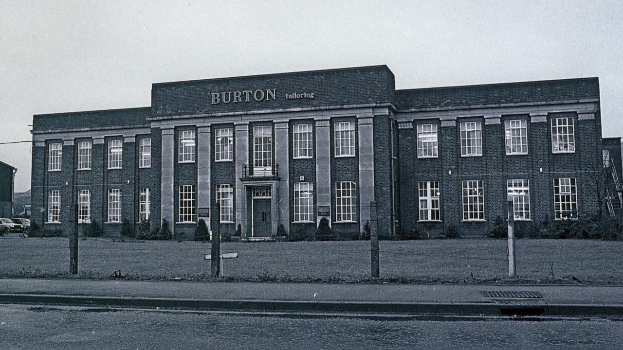 An imposing brick-built, two-storey factory comprising three joined sections. 