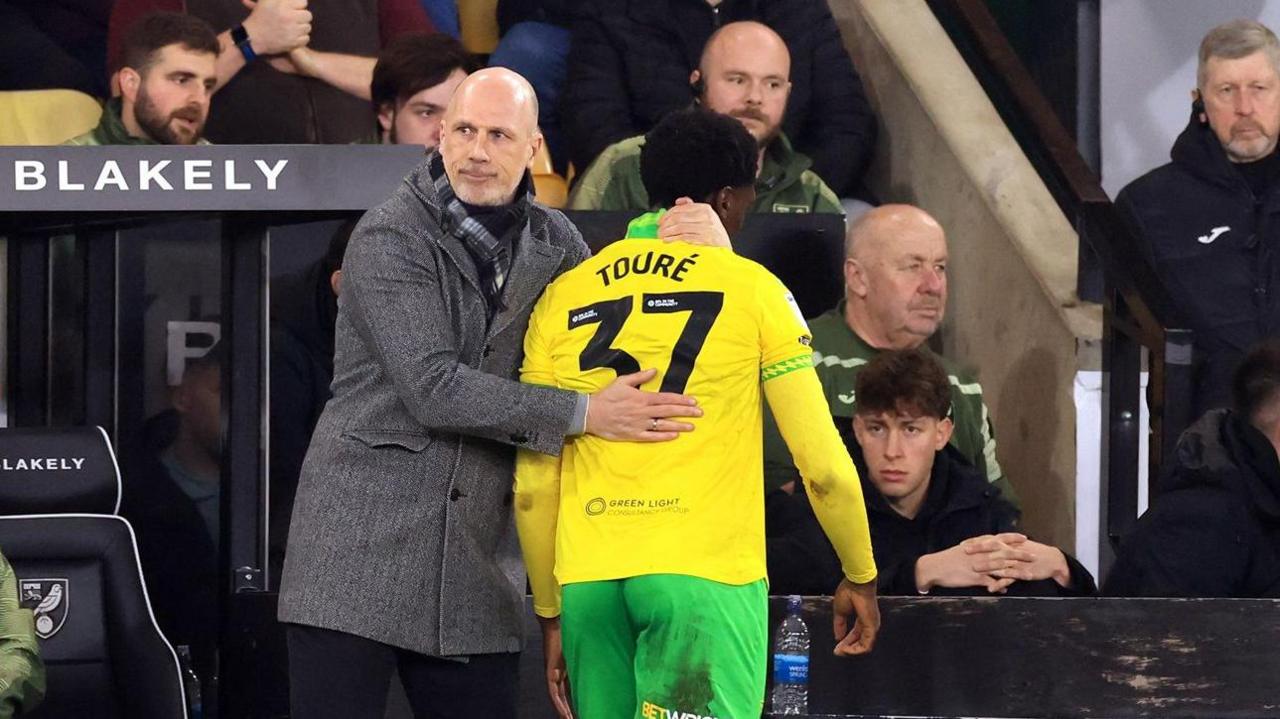 Mohamed Toure is consoled by boss Philippe Clement as he leaves the pitch early in the game