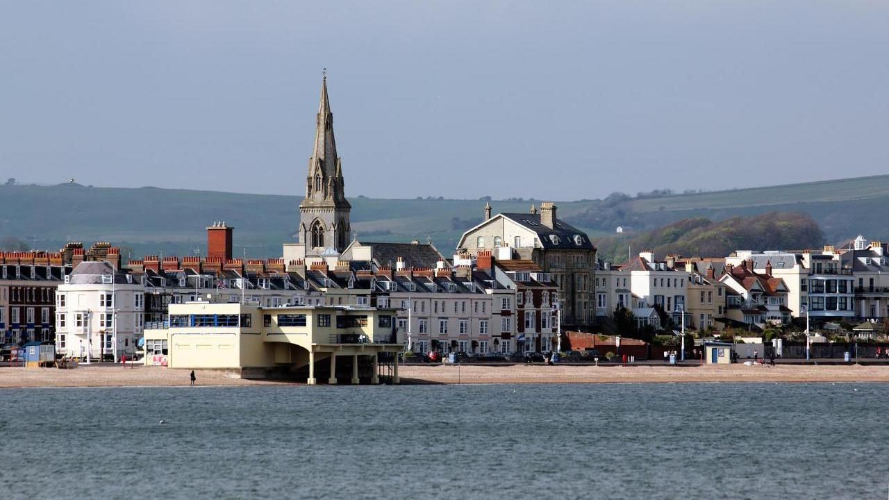 View of Weymouth promenade and seafront from the water