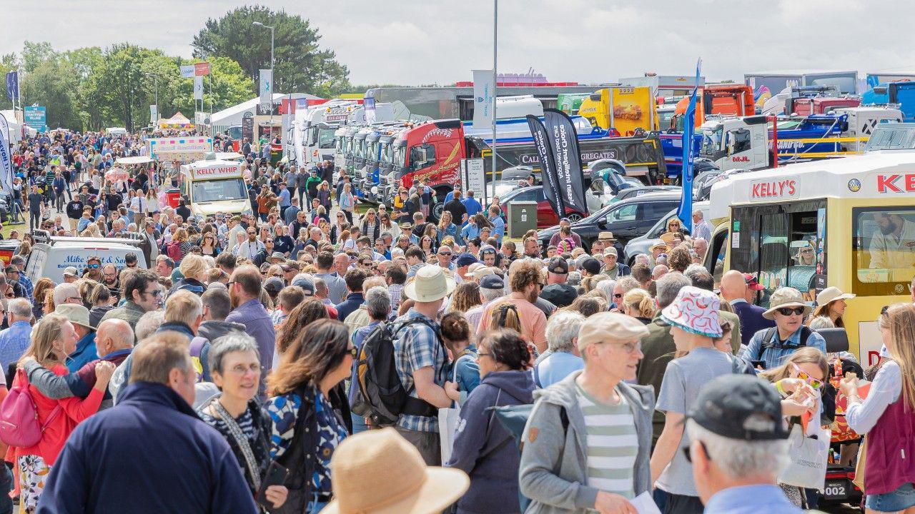 Huge crowds of people throng on a walkway at the Royal Cornwall Show