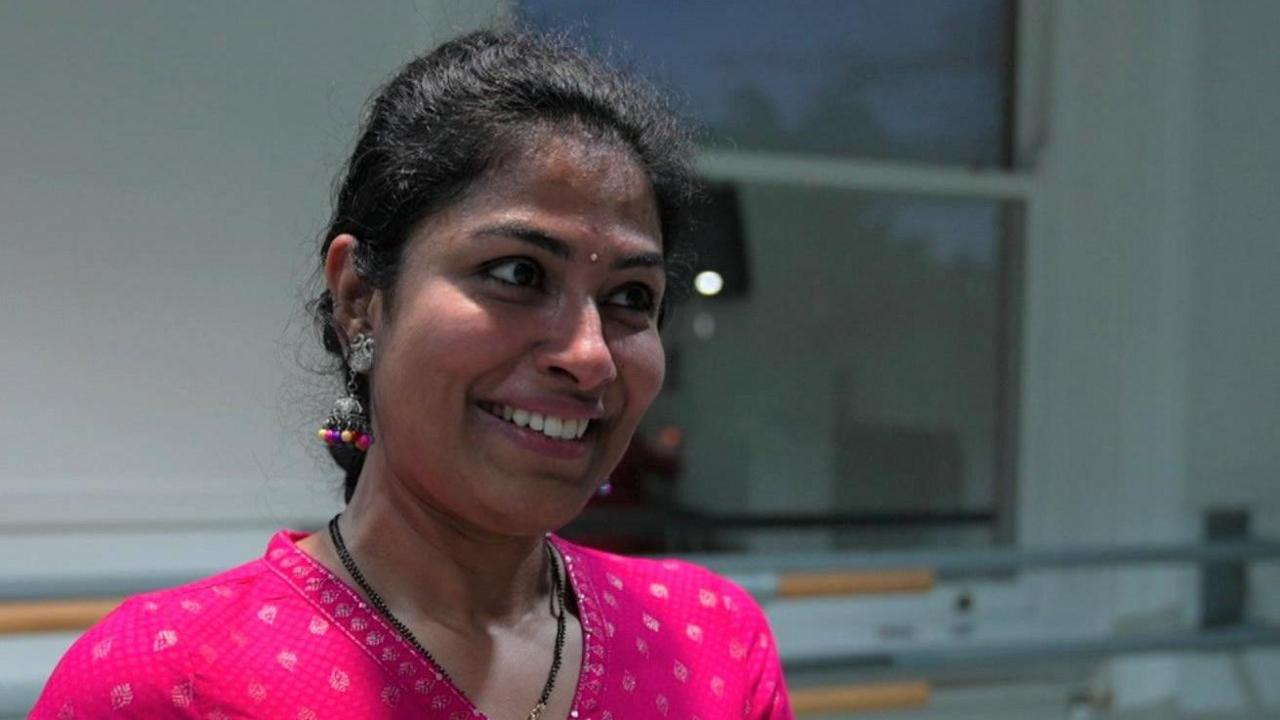 Smiling woman in pink traditional Indian dress