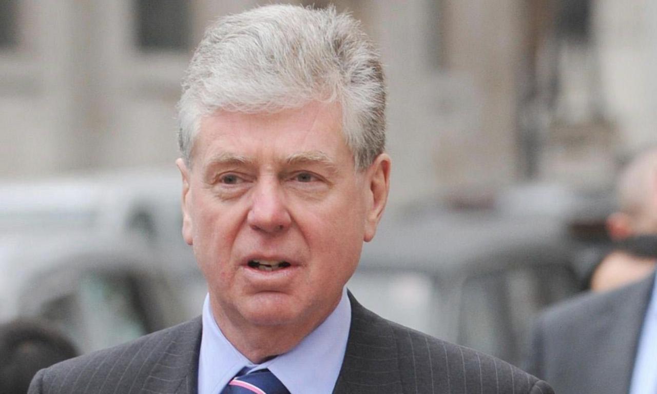 Michael Cole, Fayed's former spokesman wearing a pinstripe suit and a striped tie, pictured outside the High Court in 2008