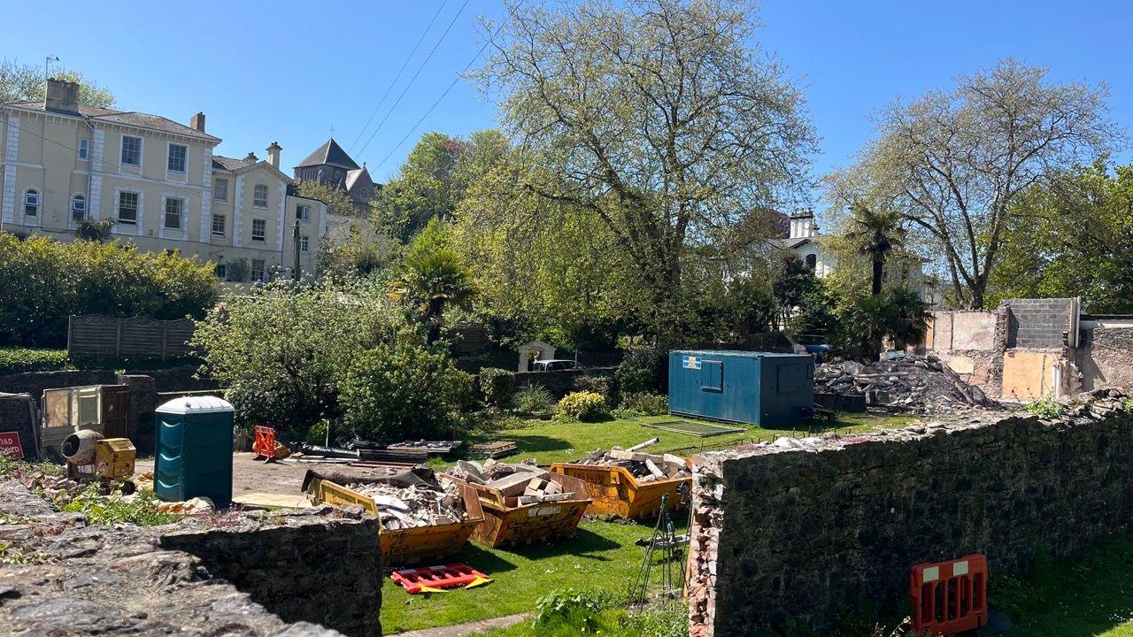 The Singleton Gardens site with three skips and a portable toilet