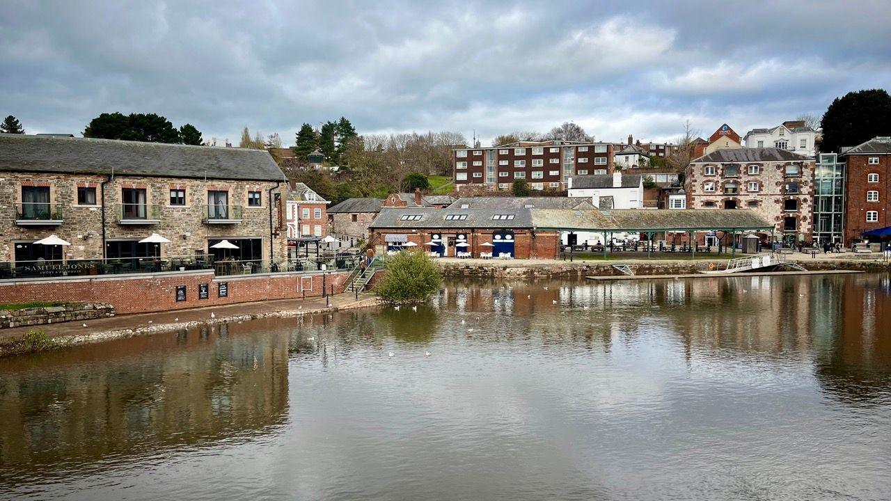 A view of Exeter quayside showing where the bridge used to be - with the Samual Jones pub on the left and the Riverside Cafe on the other side of the quay.