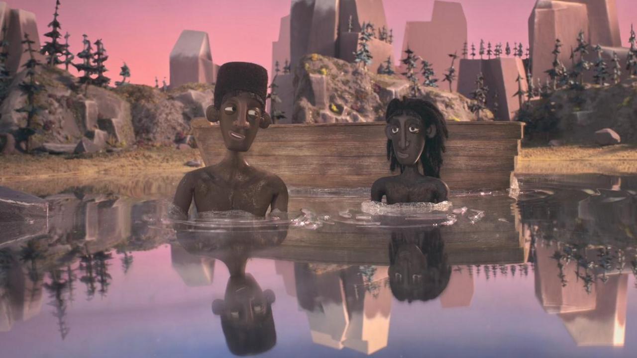 A still from the animated film shows two boys sitting in calm water under a pink and purple sky.
