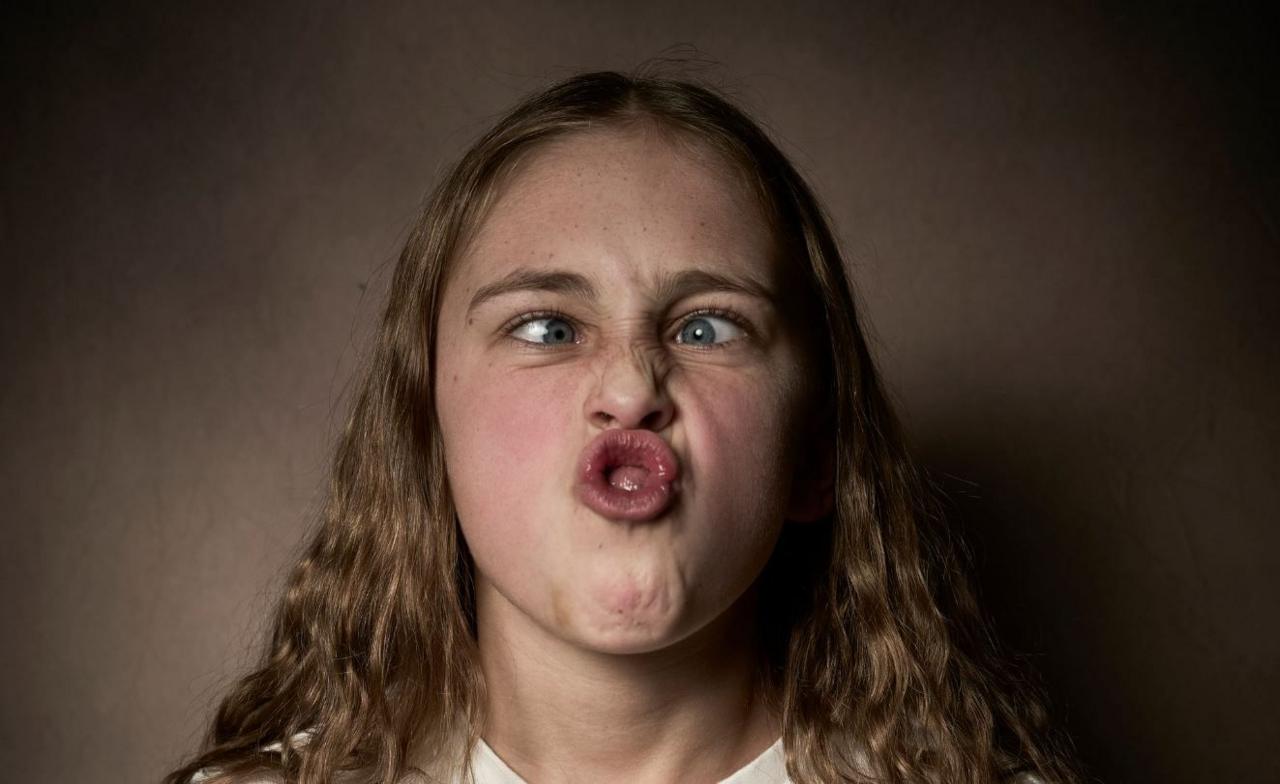 Kendall, the junior champion, has long wavy blond hair and has her eyes crossed and lips pushed out in an "o" shape