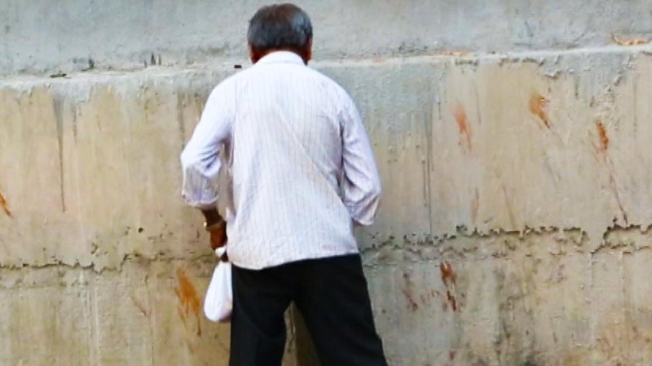 A man urinating on the street in Bangalore