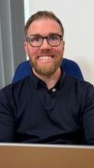 Man smiles at the camera.