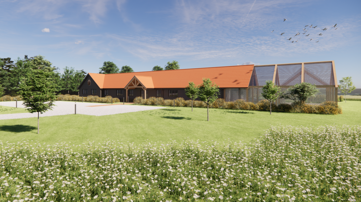 A mock-up image of what the hospital could look like. It's a large, wide building set amongst trees, grass and nature.