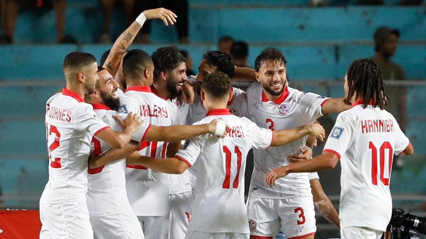 Tunisia players celebrate a goal