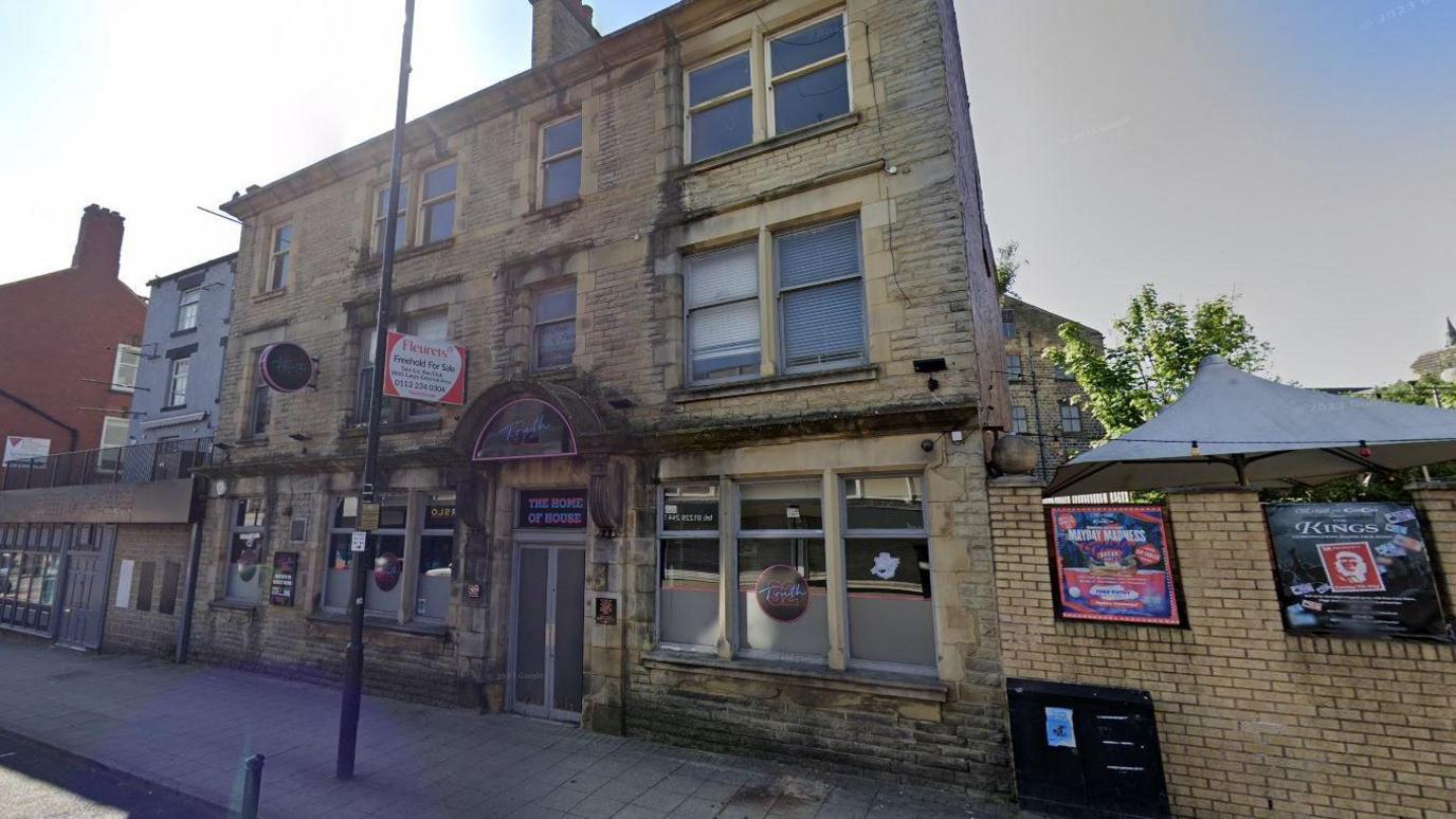A three-storey former nightclub. The brick-built building has a for sale sign on the front.
