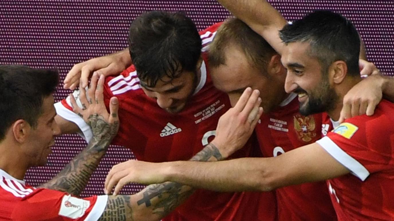 Russia midfielder Denis Glushakov (second right) is congratulated by team-mates