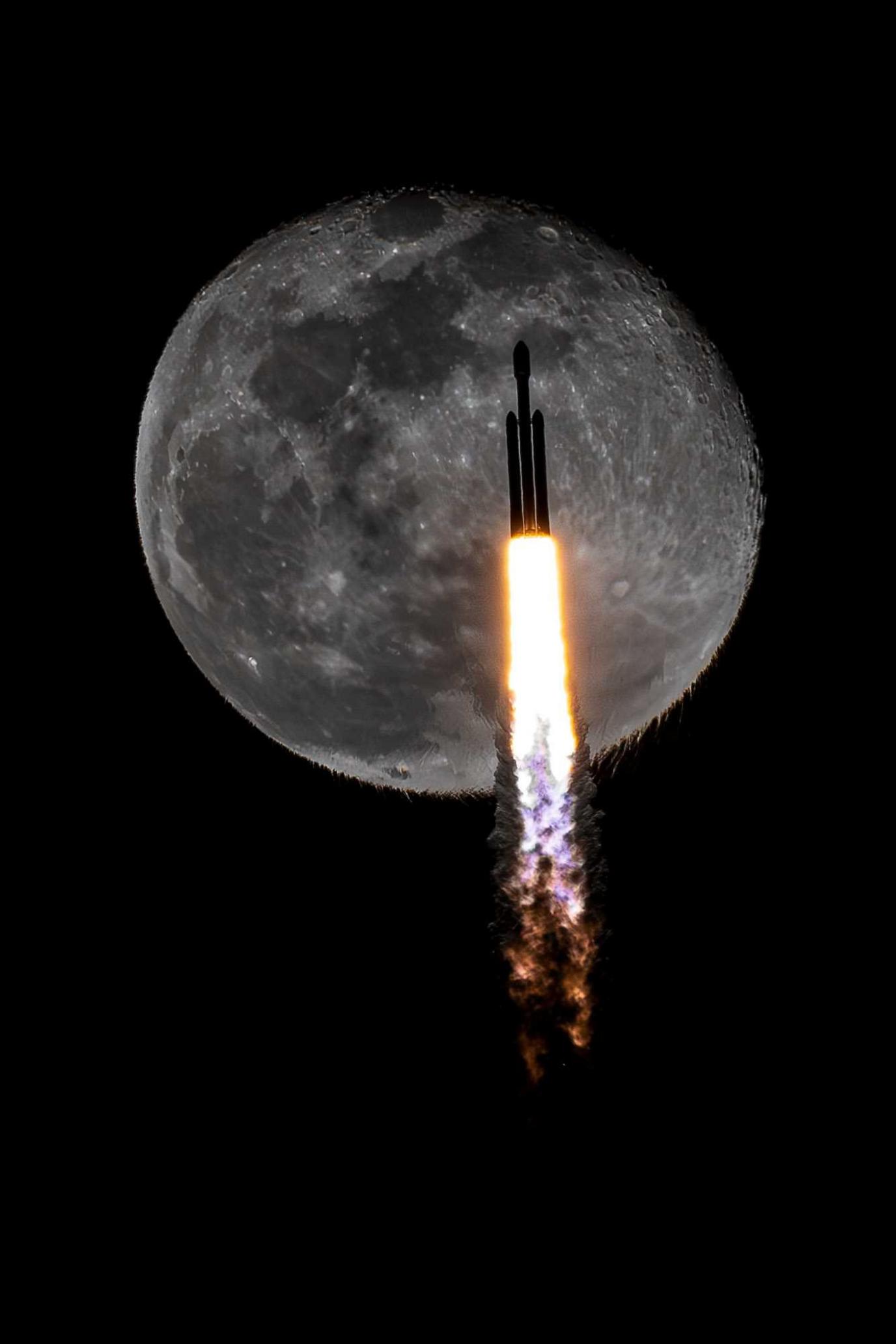 A SpaceX Falcon Heavy rocket transits the moon carrying the X-37B space plane into orbit. Shockwaves from the rocket cause a ripple effect across the moon.