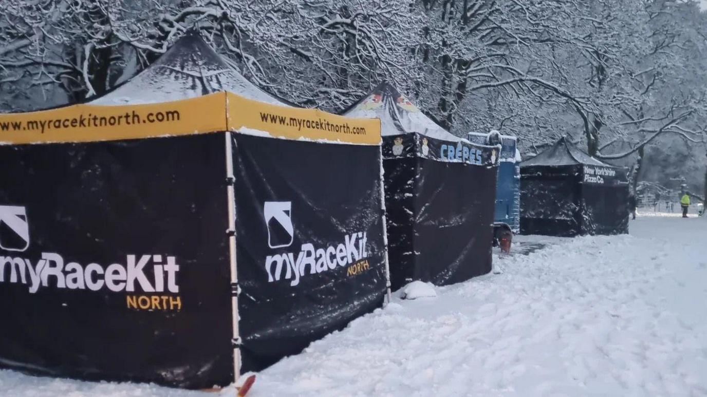 Race tents covered in snow.