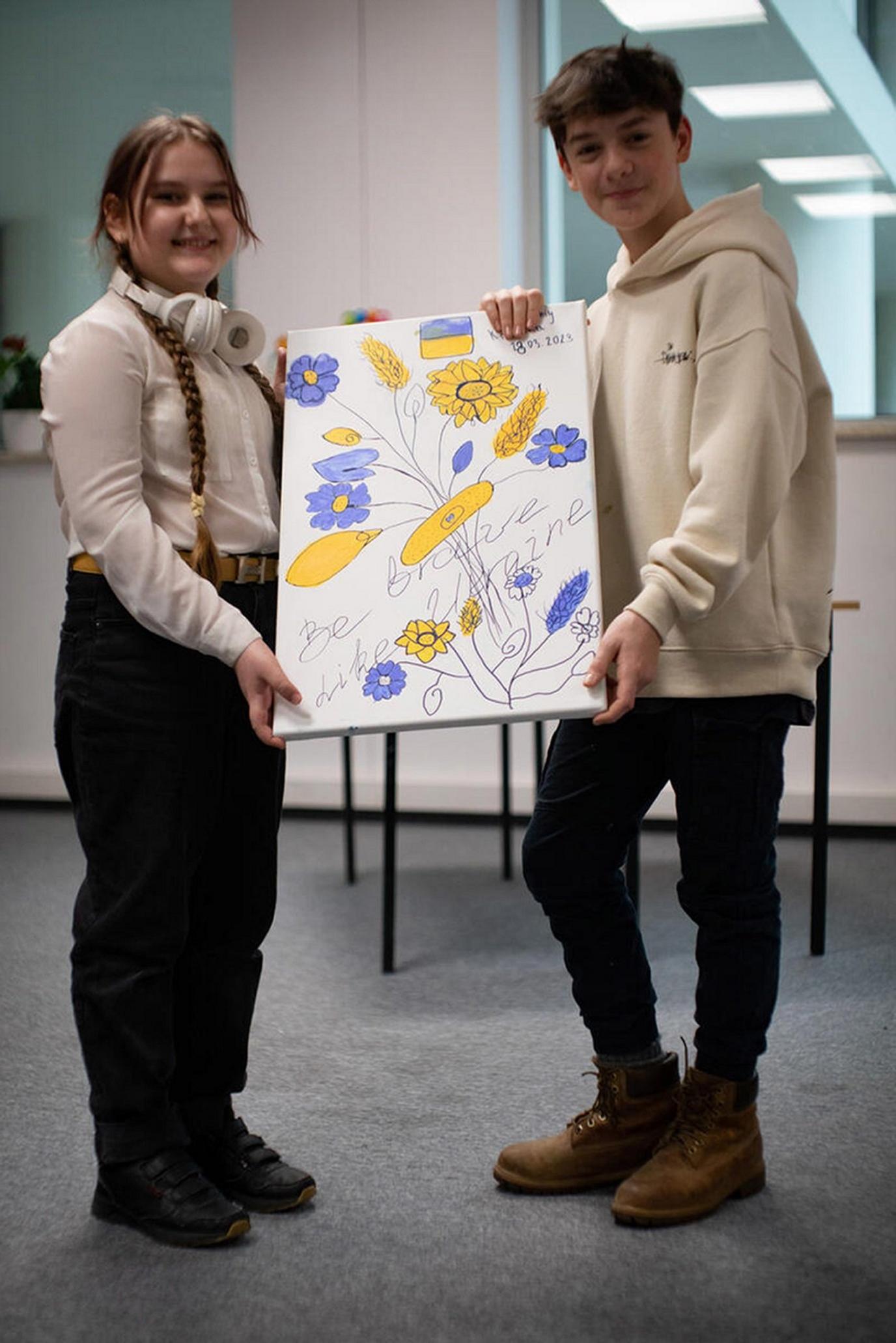 boy-and-girl-holding-painting.