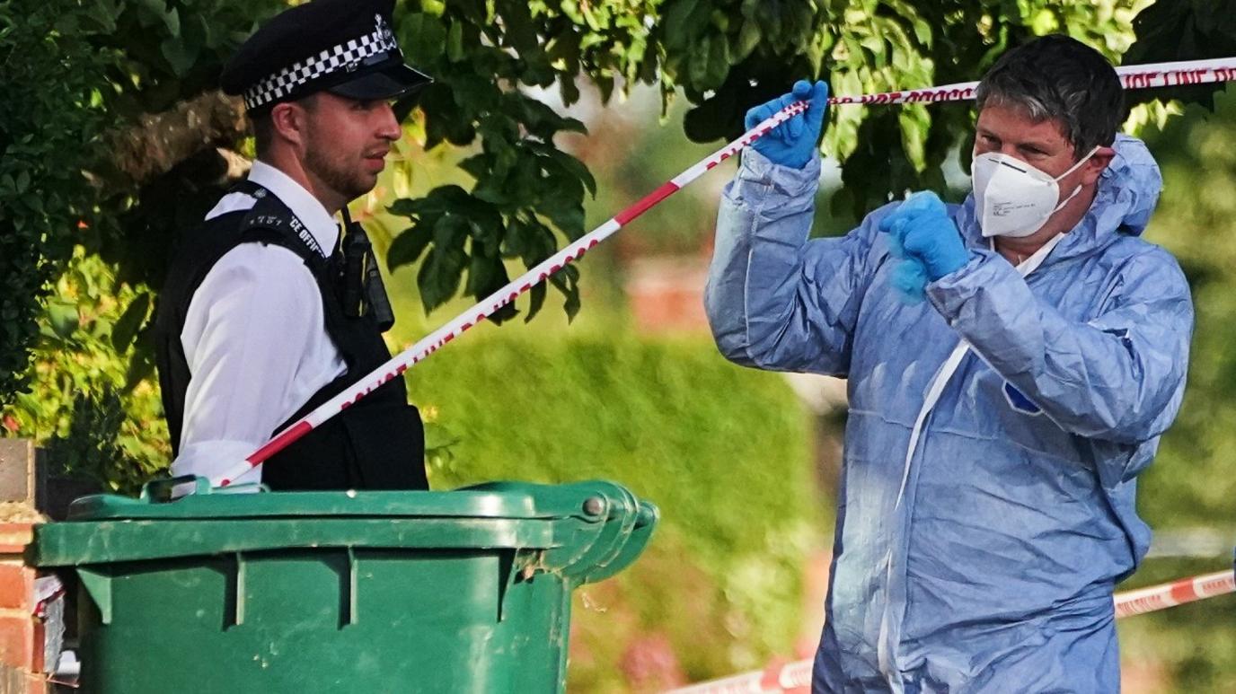 The scene in Brookside South, Barnet, north London, after a 37-year-old woman and five-year-old child were found fatally stabbed