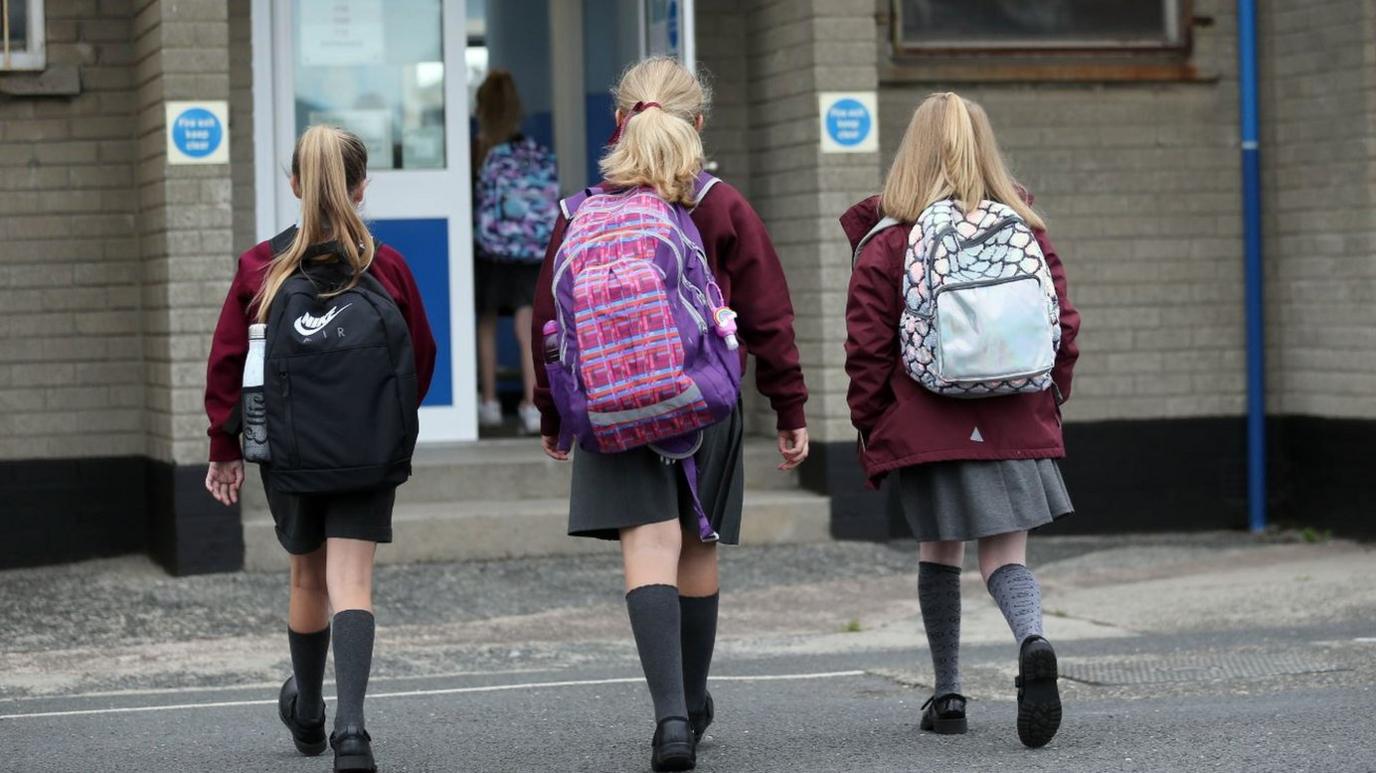 Girls arriving at Brooklands Primary School in Dundonald in September