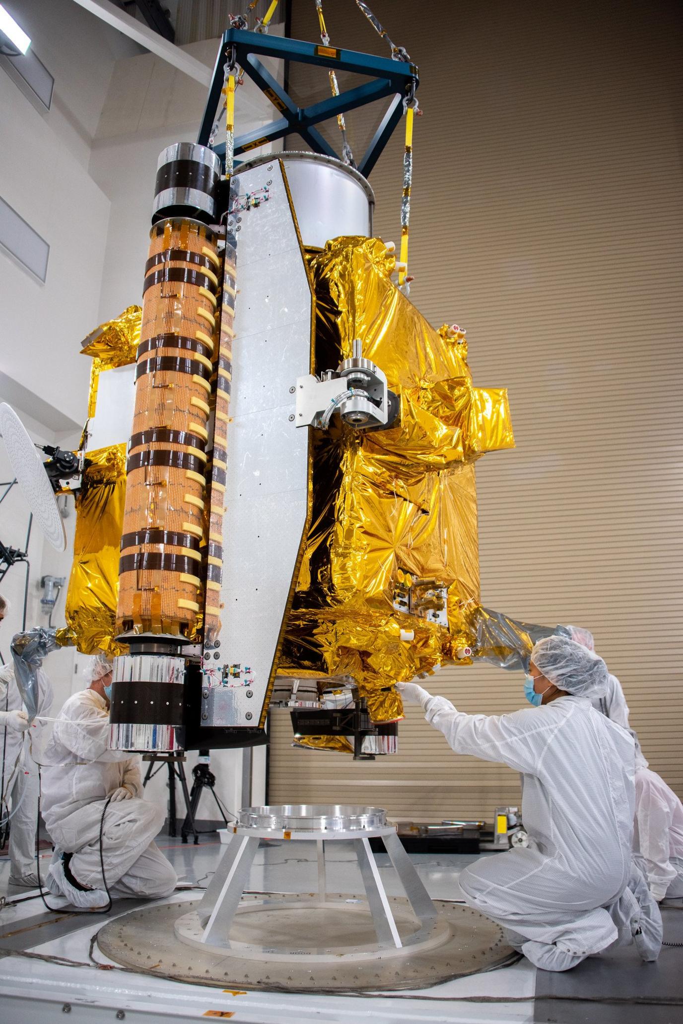 Scientists lowering the Dart spacecraft onto a base