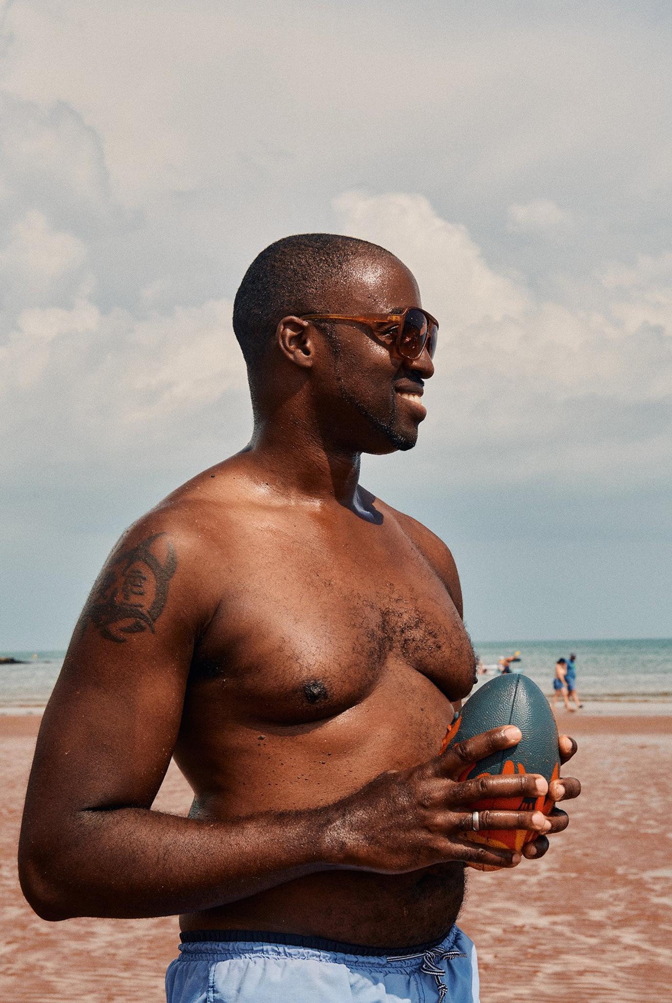 Gervan plays catch with his son on the beach at Goodrington Sands