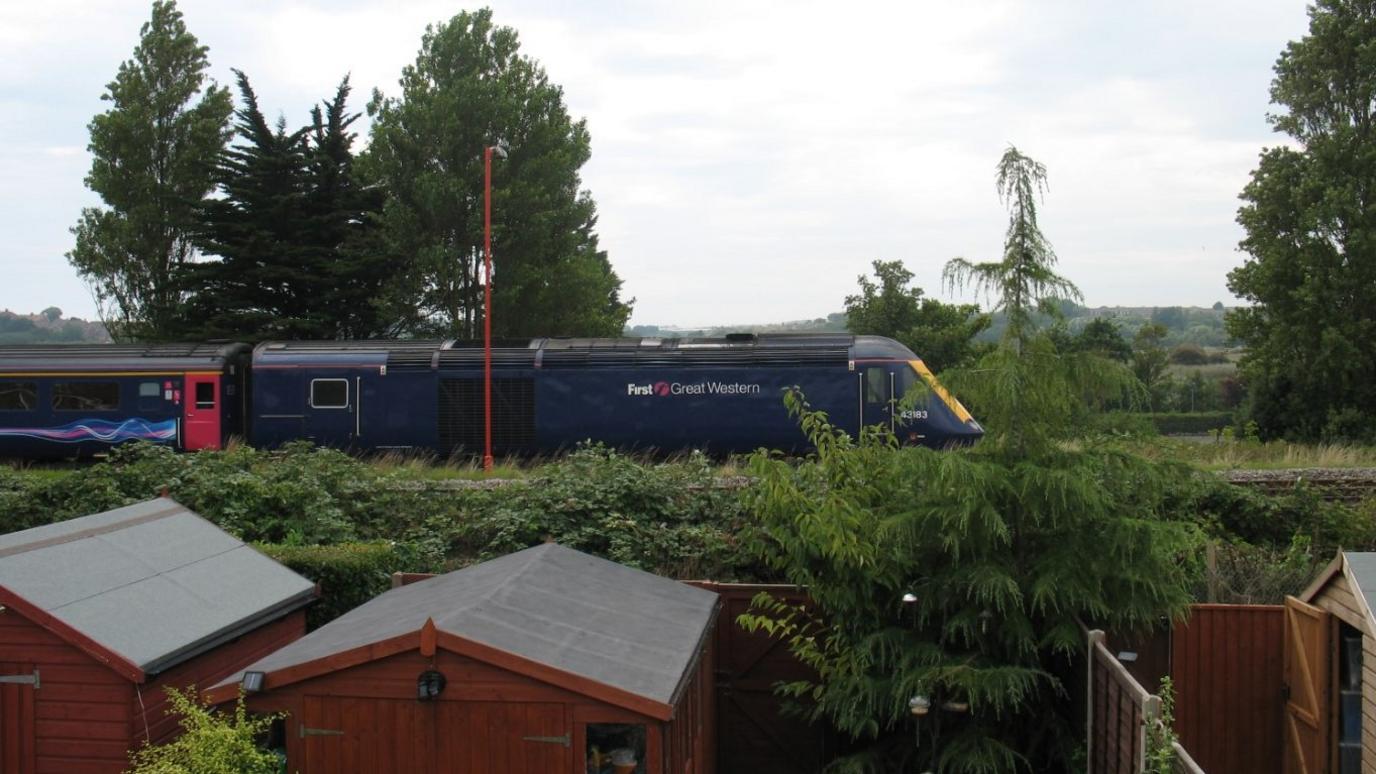 A train sitting with its engine running outside Diane and Mark Whitchelo's home