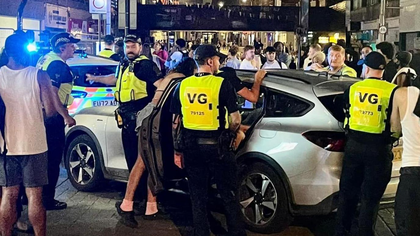 Police officers around a car in Southend city centre