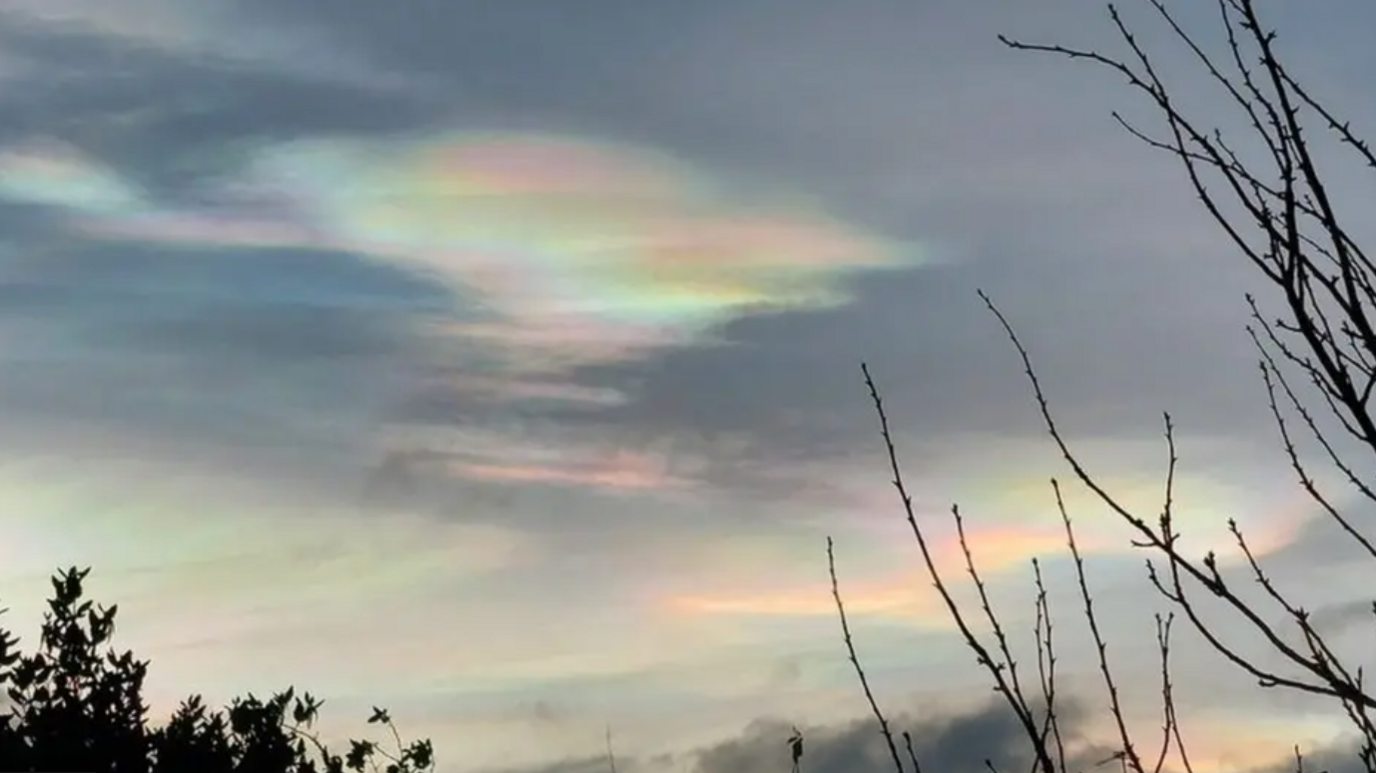 An image of a rainbow cloud in the sky