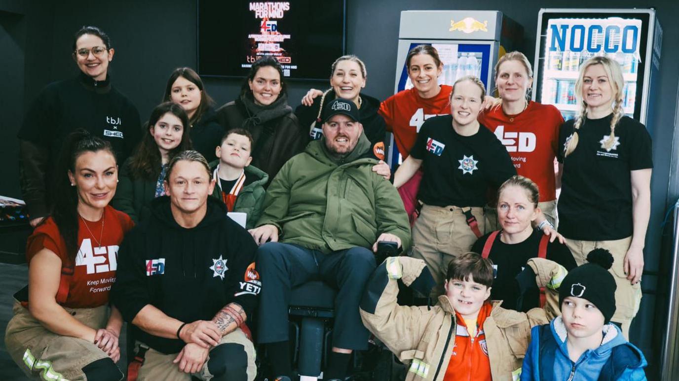 Ed Slater poses with members of the Gloucestershire Fire and Rescue Service's team that are raising money for his charity.