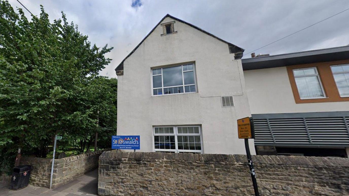 St Oswalds' Primary School. It is a white two-storey building.