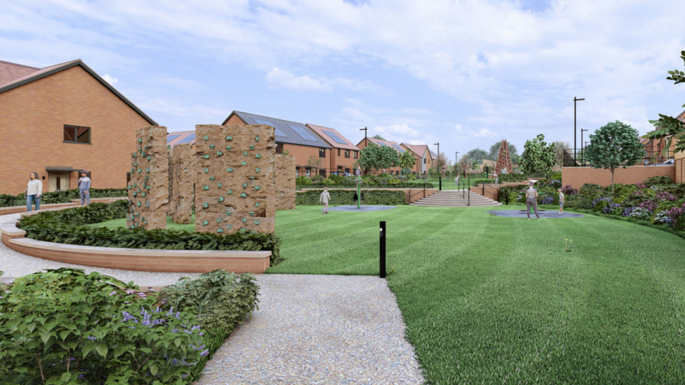 Artist's impression of new houses with a stone design in the centre with grass around it with houses then surrounding the circular green space.