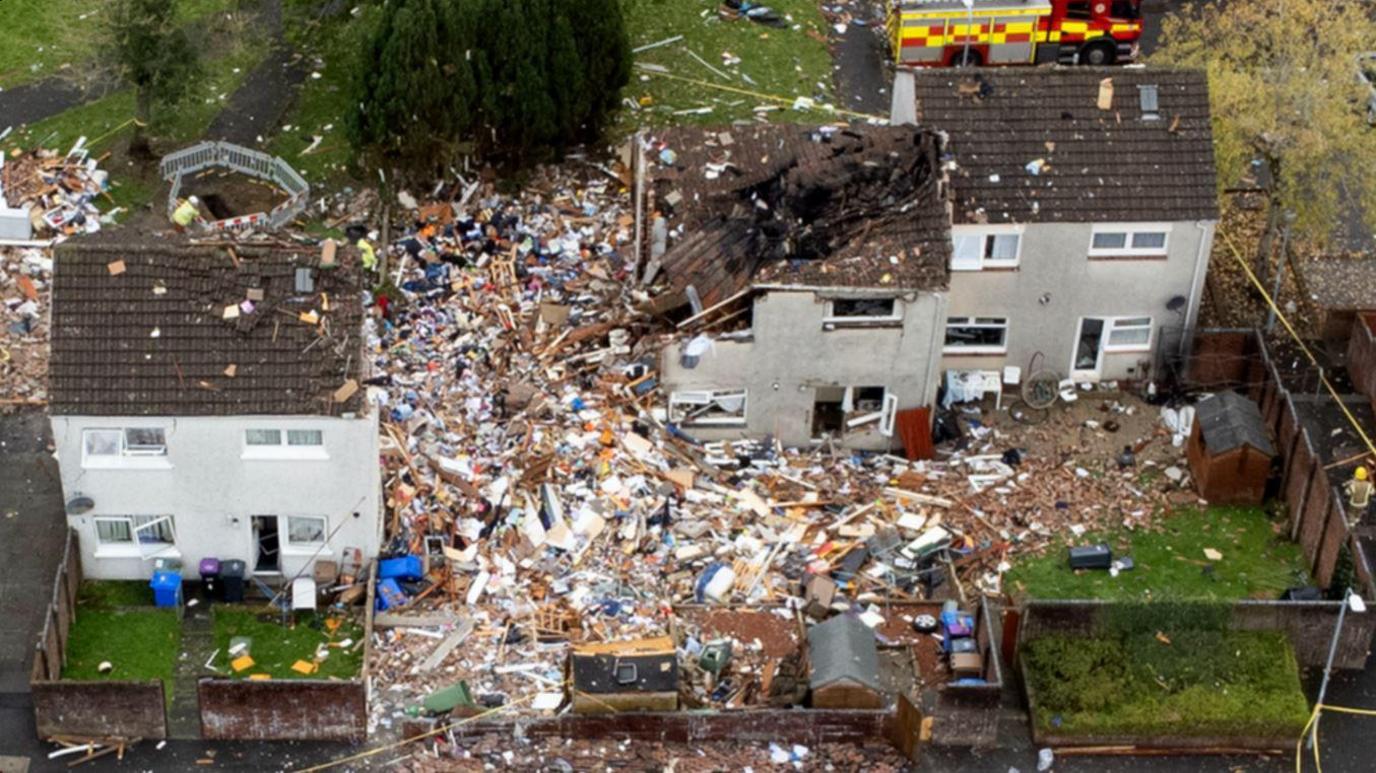 Four houses, one of which is completely destroyed following an explosion