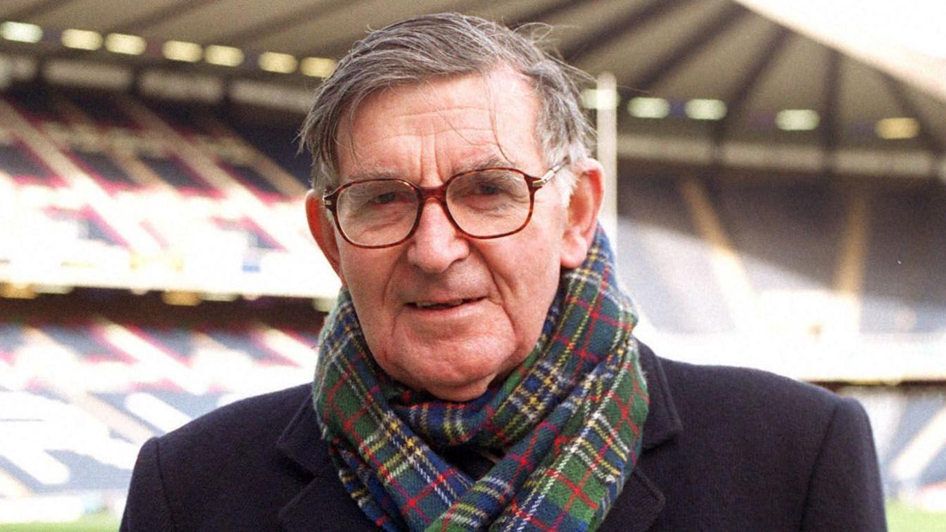 The late rugby commentator Bill McLaren in glasses with a big tartan scarf wrapped around his neck