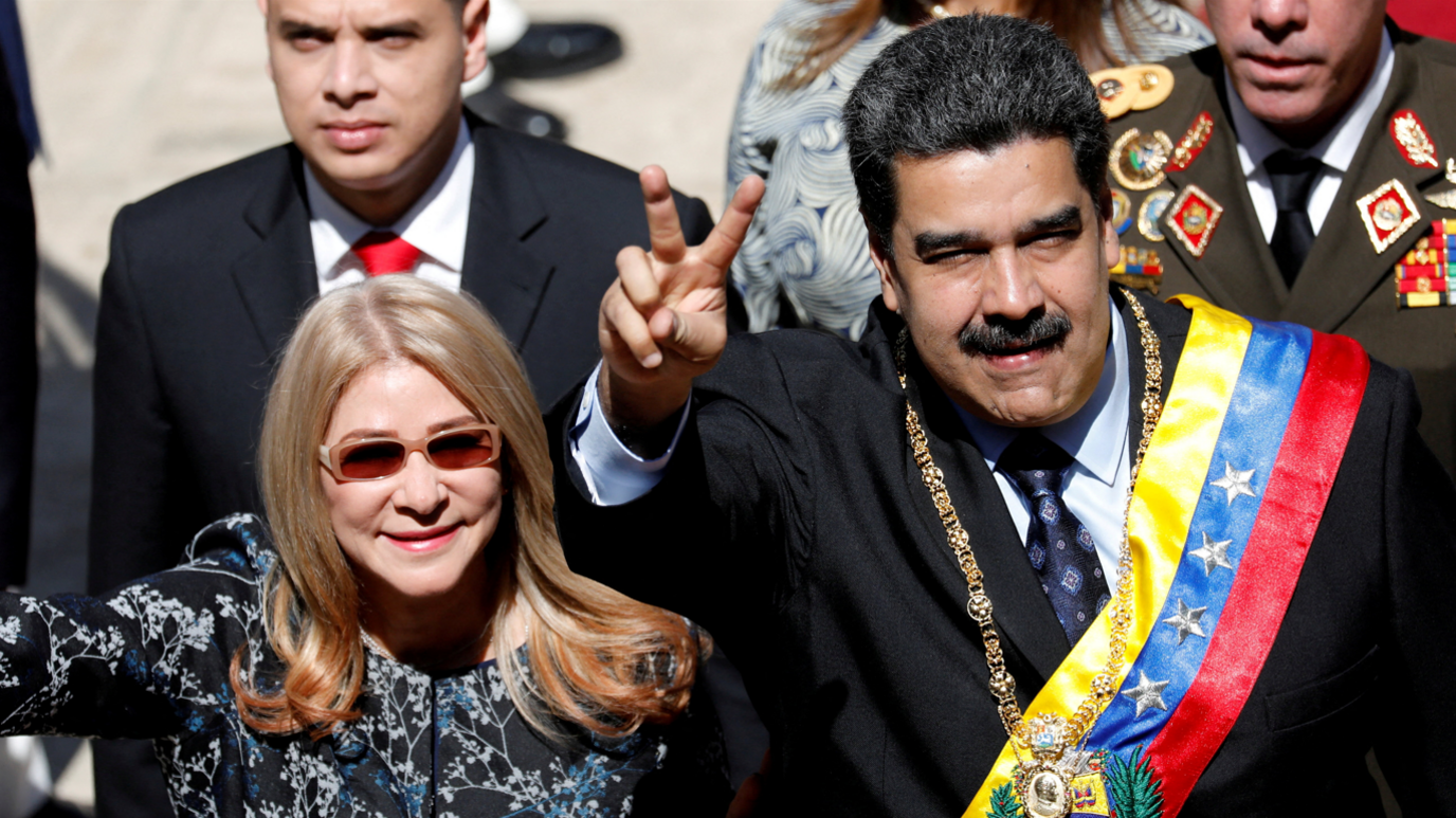 Venezuela's President Nicolas Maduro gestures next to his wife Cilia Flores during his arrival for a special session of the National Constituent Assembly 