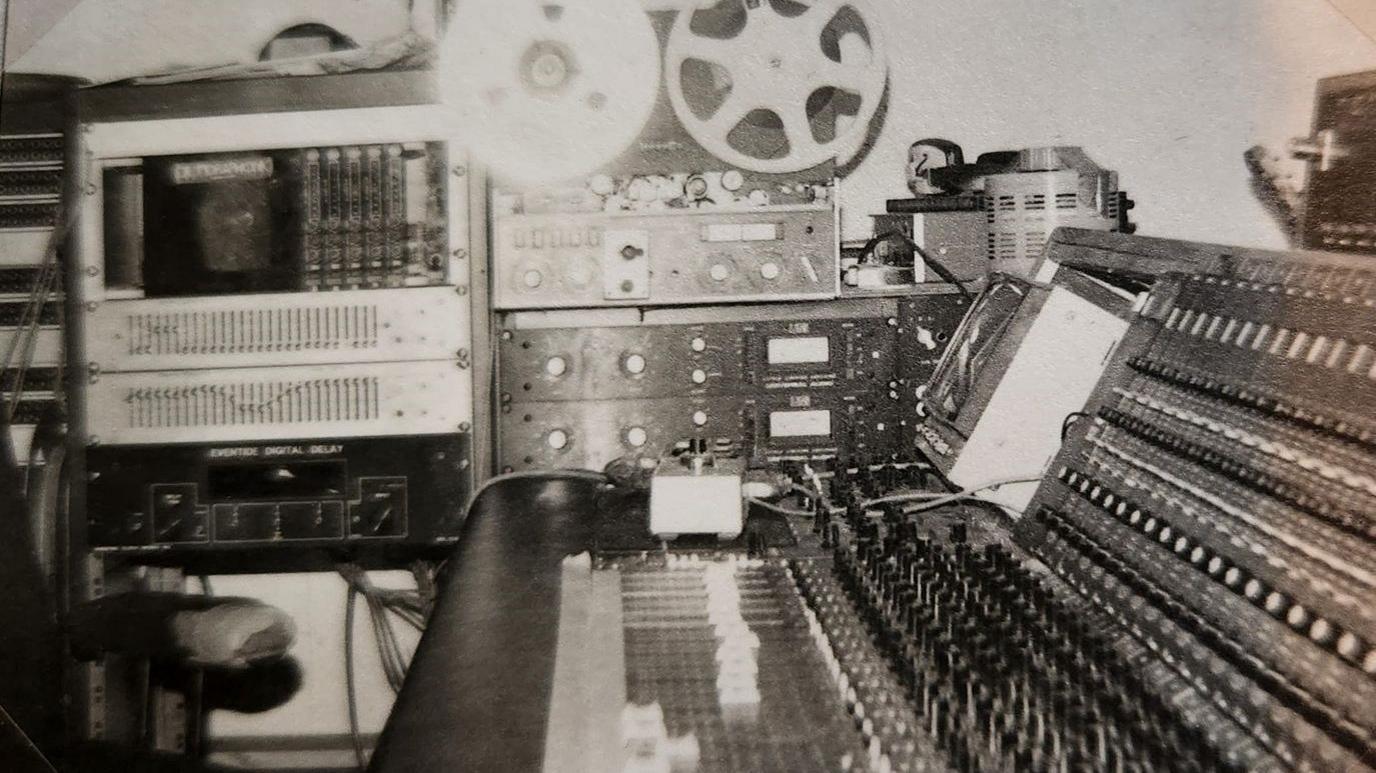 A black and white photograph of a recording studio in the 1970s