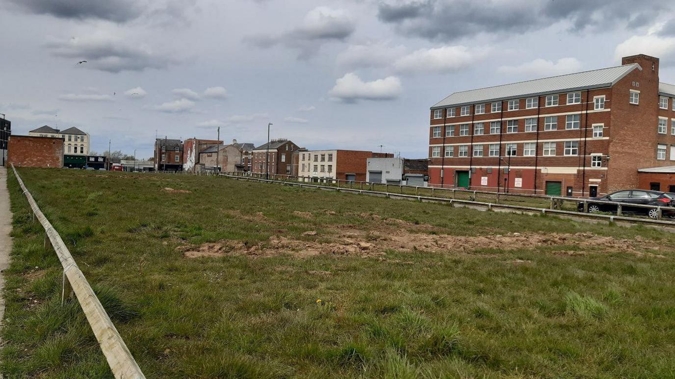 The site of the proposed housing development at Sunniside, currently a fenced-off field