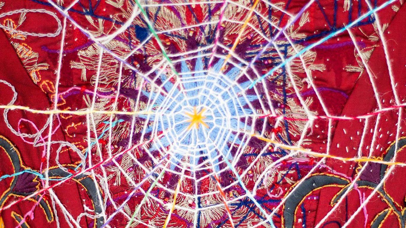 A close up of some embroideries from The Red Dress
