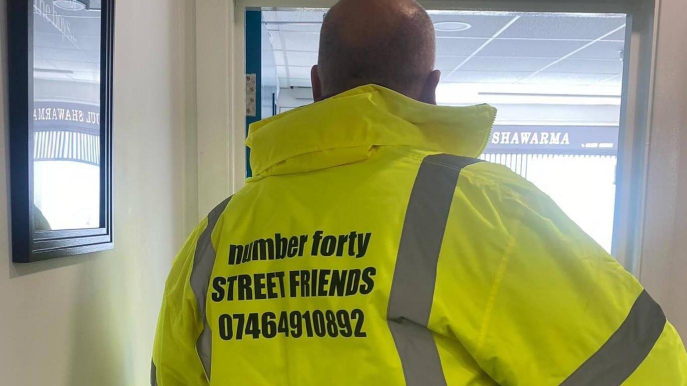 A man in a high visibility jacket