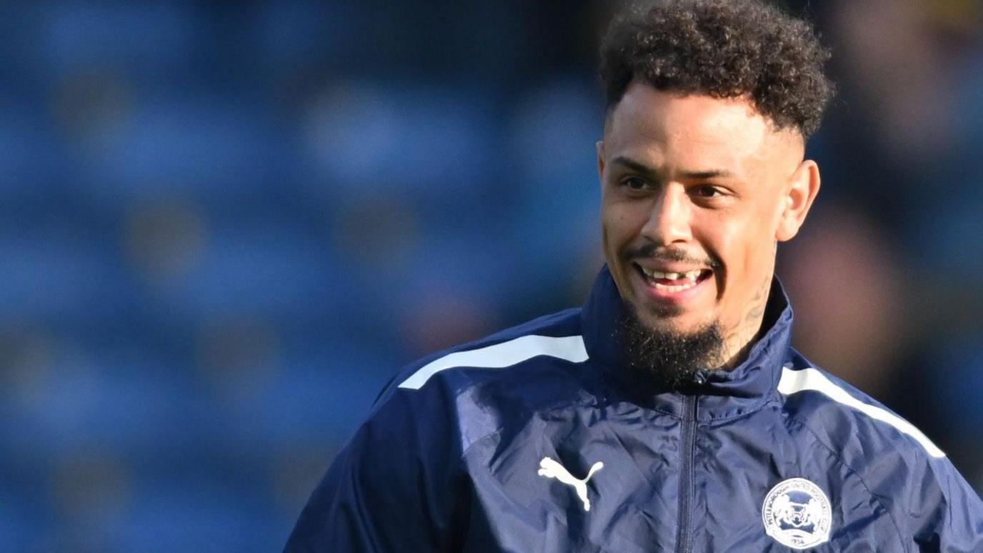  Jonson Clarke-Harris smiles while warming up for Peterborough