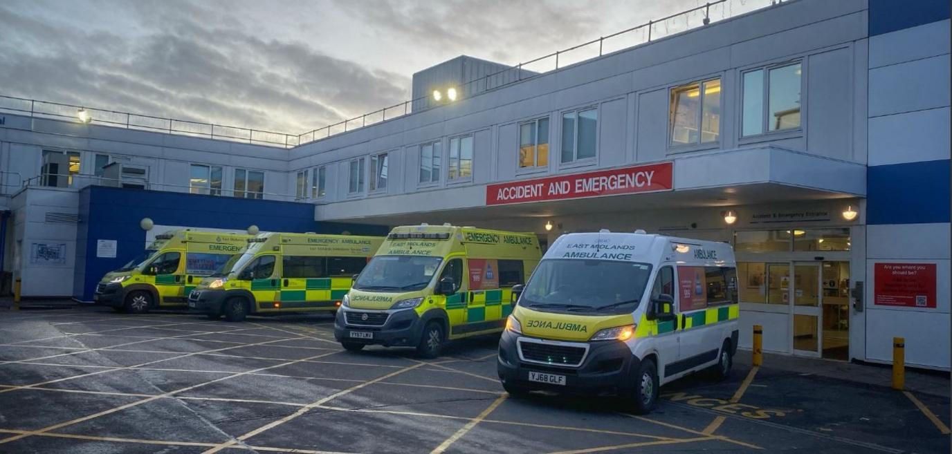 Northampton General Hospital's accident and emergency department with ambulances lined up outside.