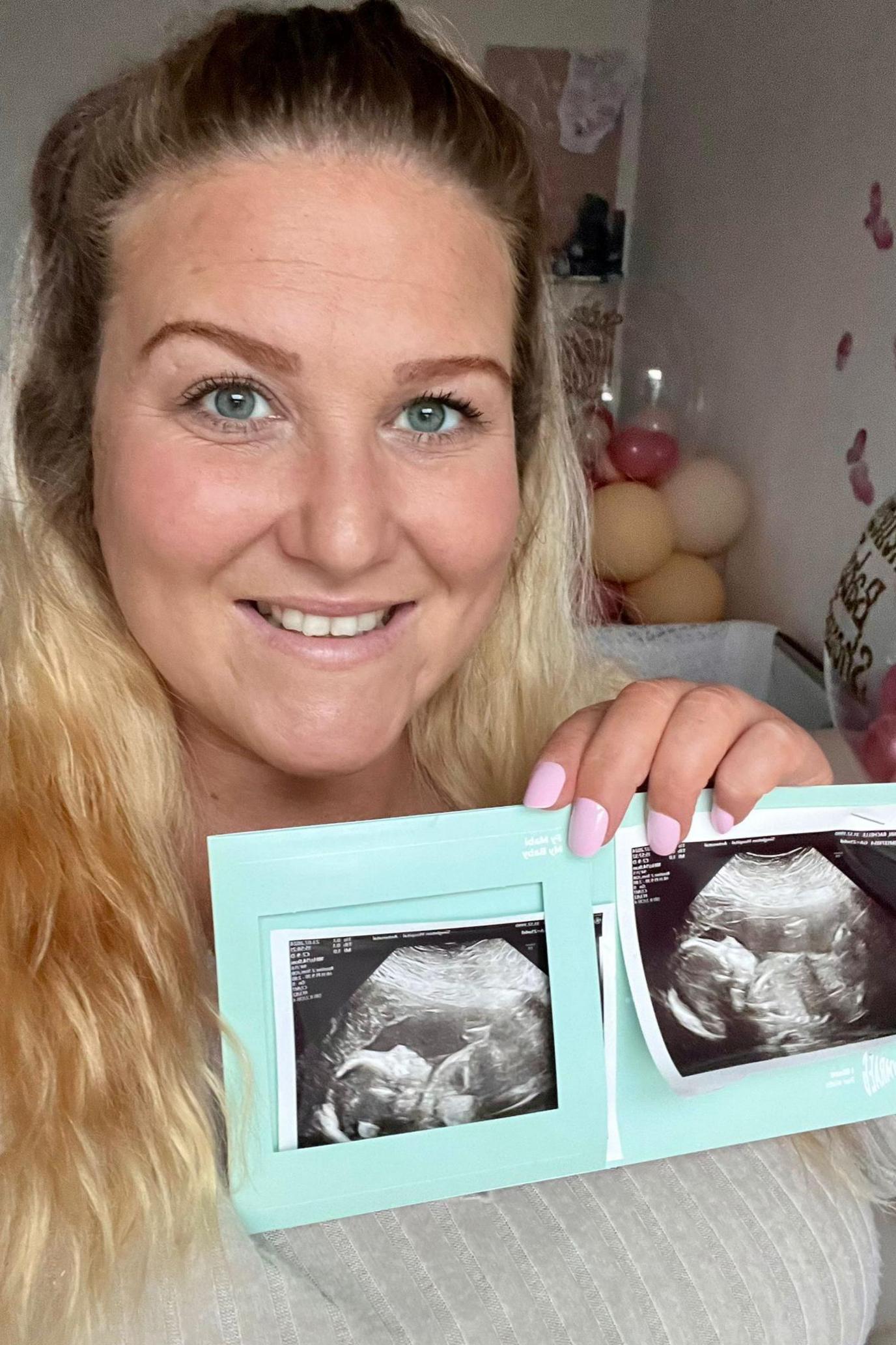 Shelley Romaniuk holding a photo of her recent ultrasound scan