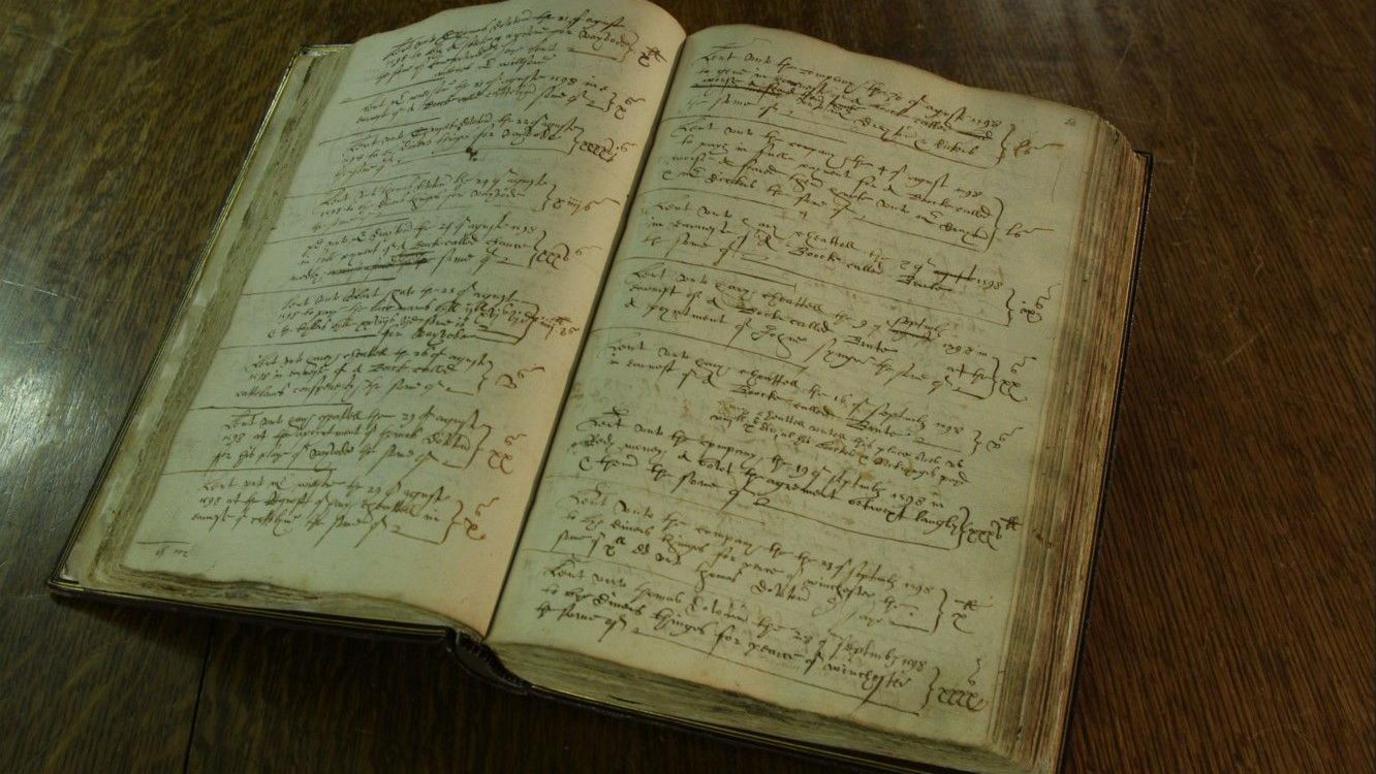 Henslowe's diary. A yellowed open book full of handwritten notes in elaborate handwriting.