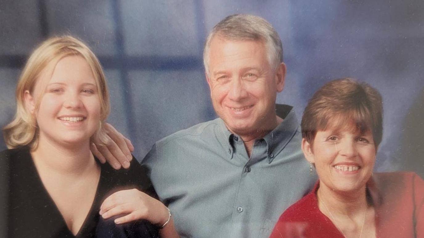 Claire Goring (left) sat pictured with her dad and mum, Robert and Christine