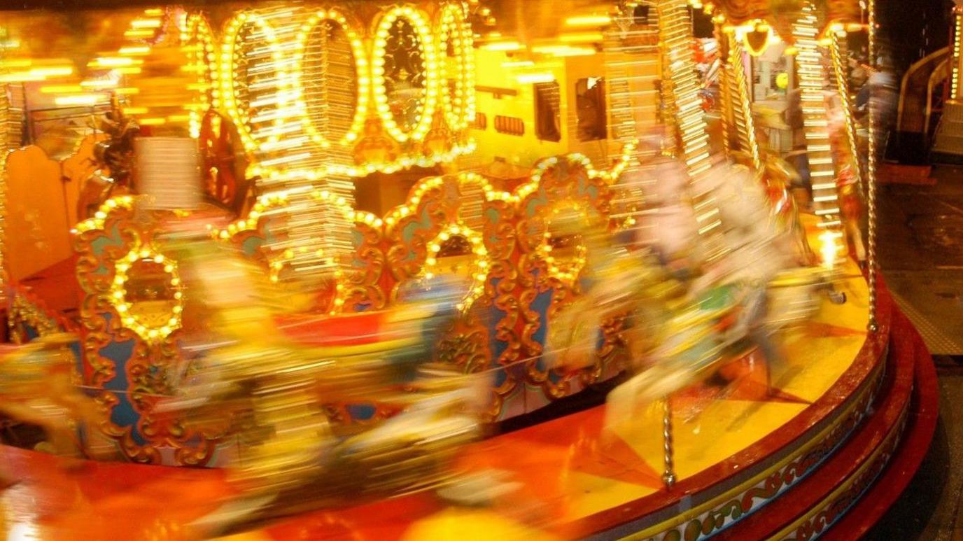 A carousel in a blur of light at night