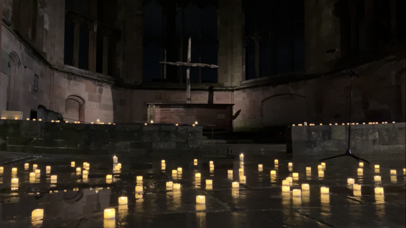 Lit candles on the floor on ruins of the Coventry Cathedral for the blitz memorial